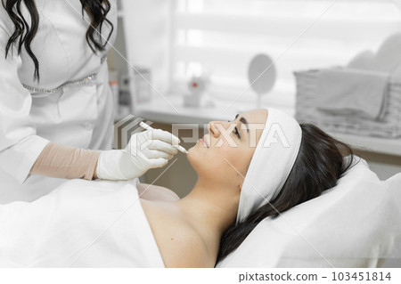 Smoothness and perfection where botulinum therapy becomes a real savior for woman, helping to maintain smoothness of the skin and achieve perfection in appearance in a beauty salon at a cosmetologist 103451814