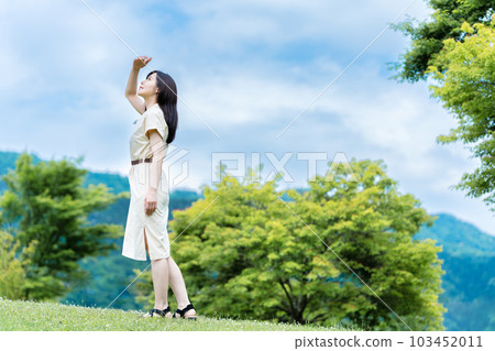 A woman enjoying the fresh green 103452011