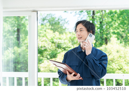 Staff wearing work clothes contacting by smartphone 103452510