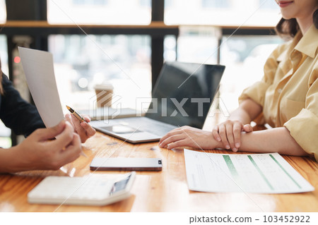 Asian Business team makes analysis and research financial report at office, analyzes profits. Accountant checks status of financial 103452922