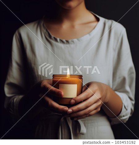 Woman holding burning candle, design and branding ready candle jar mockup with female hands, no face 103453192