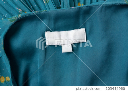 White blank laundry care clothes label on fabric background White blank laundry care clothes label on fabric background 103454960