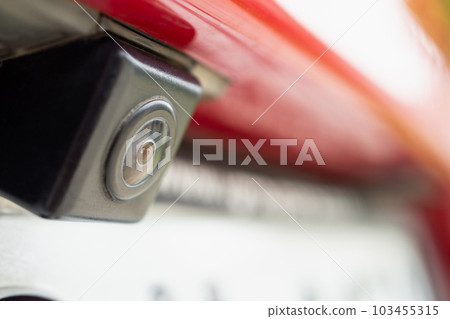 Red car rear view camera close up for parking assistance Red car rear view camera close up for parking assistance 103455315