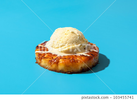 Grilled pineapple with vanilla ice cream, isolated on a blue background 103455741