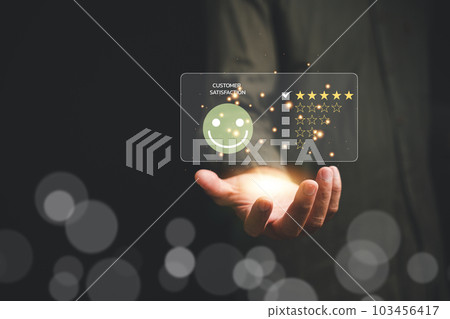 Hands holding five gold stars, symbolizing customer satisfaction and excellence in service. Perfect for online reviews and feedback. Customer service and Satisfaction concept, 5 star rating 103456417