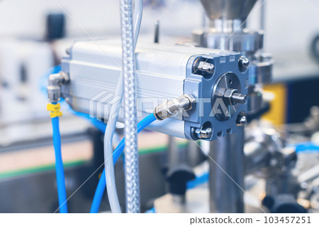 Many pneumatic hose fittings that connect to air or water hoses are installed on pneumatic equipment on a production line 103457251