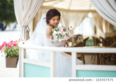 Beautiful bride with wedding flowers bouquet, attractive woman in wedding dress. Happy newlywed woman. Beautiful bride with wedding flowers bouquet, attractive woman in wedding dress. Happy newlywed woman. 103457475