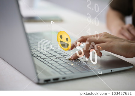 Businesswoman pressing face emoticon on the keyboard laptop .Customer service evaluation concept. 103457651
