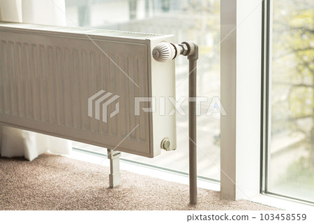 Modern radiator in central heating system in apartment 103458559
