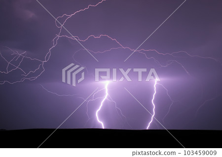 Ray. Lightning. Electric storm. Strong electrical storm with a multitude of lightning and thunder. Lightning storm over fields of Spain. Photography of lightning. 103459009