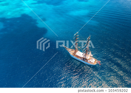 Aerial view of beautiful sailboat in blue sea at sunset in summer Aerial view of beautiful sailboat in blue sea at sunset in summer 103459202