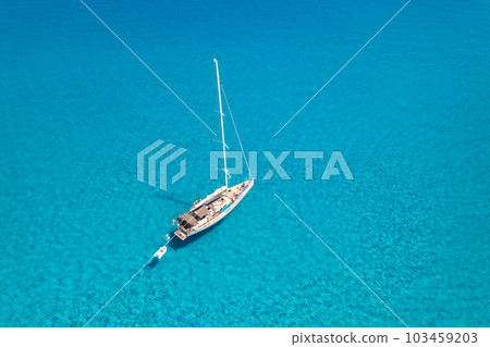 Aerial view of beautiful sailboat in blue sea at sunset in summer Aerial view of beautiful sailboat in blue sea at sunset in summer 103459203