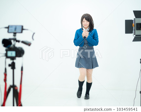 A high school girl taking a picture of a dance 103459541