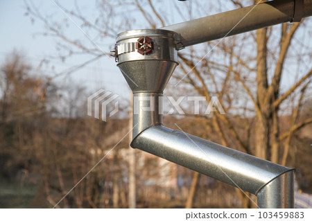 Galvanized Metal Gutters from Roof. Corner of House with Gutters 103459883
