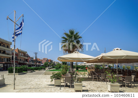 Empty outdoor seafront cafes with chairs and tables at summer in Lixouri Town on the Ionian Island of Cephalonia Greece. 103460611