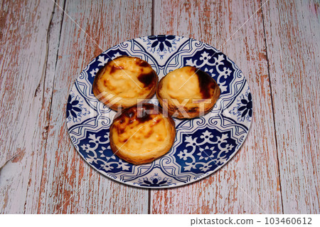 Pasteis De Nata, Pastel de Belem, traditional Portuguese miniature egg custard pastry cakes served on a dish. 103460612