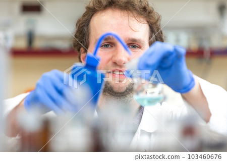 Male researcher doing research experiment in a chemistry lab, concept of chemist laboratory Male researcher doing research experiment in a chemistry lab, concept of chemist laboratory 103460676