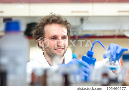 Male researcher doing research experiment in a chemistry lab, concept of chemist laboratory 103460677