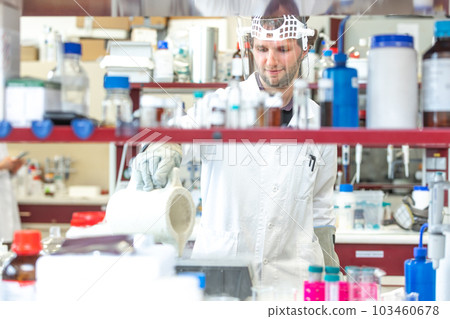 Male researcher doing research experiment in a chemistry lab, concept of chemist laboratory Male researcher doing research experiment in a chemistry lab, concept of chemist laboratory 103460678