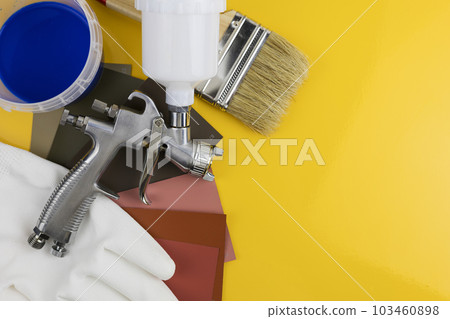 Paint spray gun at work at the workplace in the workshop. Paint Brush 103460898
