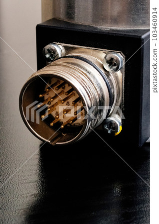 Metal encoder on a black wooden table 103460914