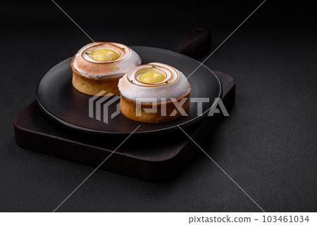Delicious tart with citrus filling and walnut cream 103461034