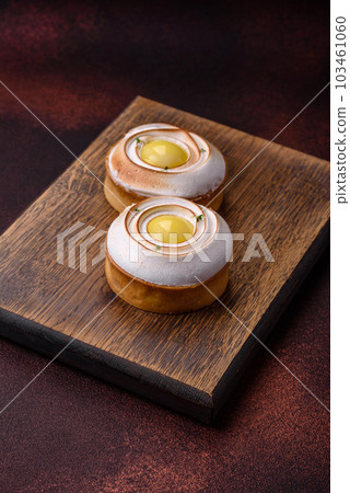 Delicious tart with citrus filling and walnut cream Delicious tart with citrus filling and walnut cream 103461060