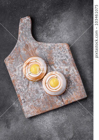 Delicious tart with citrus filling and walnut cream 103461075