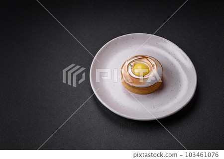 Delicious tart with citrus filling and walnut cream 103461076