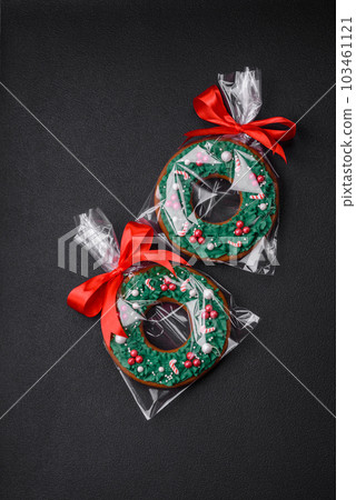 Delicious Christmas gingerbread cookies on a dark textured concrete background Delicious Christmas gingerbread cookies on a dark textured concrete background 103461121