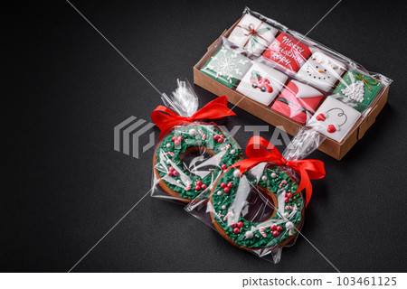 Delicious Christmas gingerbread cookies on a dark textured concrete background Delicious Christmas gingerbread cookies on a dark textured concrete background 103461125