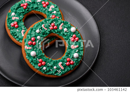Delicious Christmas gingerbread on a dark textural background Delicious Christmas gingerbread on a dark textural background 103461142
