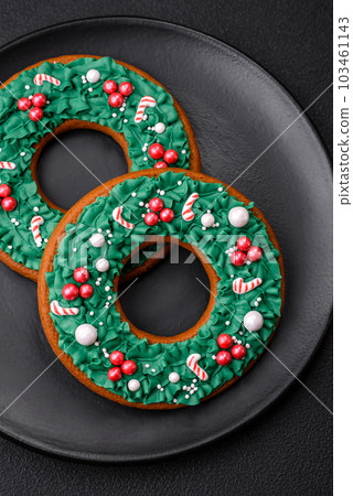 Delicious Christmas gingerbread on a dark textural background Delicious Christmas gingerbread on a dark textural background 103461143