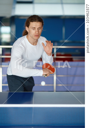 Portrait of happy male athlete playing table tennis at training sport club 103462877