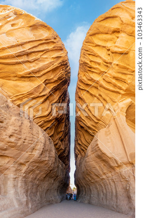 Tourist in Siq passage at Jabal Ithlib hidden nabataean cave, Al Ula, Saudi Arabia Tourist in Siq passage at Jabal Ithlib hidden nabataean cave, Al Ula, Saudi Arabia 103463343