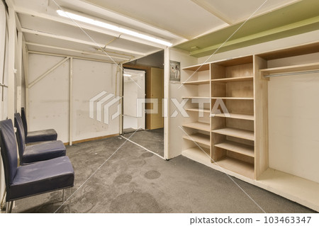 a room that is being used for storage and other things to be stored on the wall in the closet area a room that is being used for storage and other things to be stored on the wall in the closet area 103463347