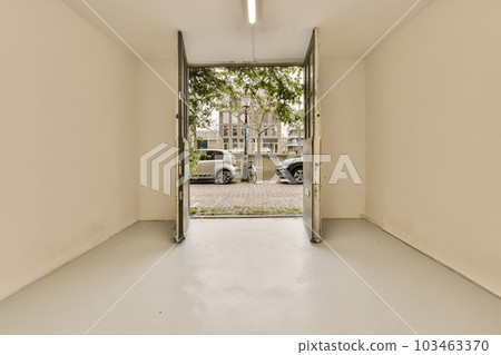 an empty room with two cars parked in the distance and one car parked on the other side, as seen from the inside an empty room with two cars parked in the distance and one car parked on the other side, as seen from the inside 103463370