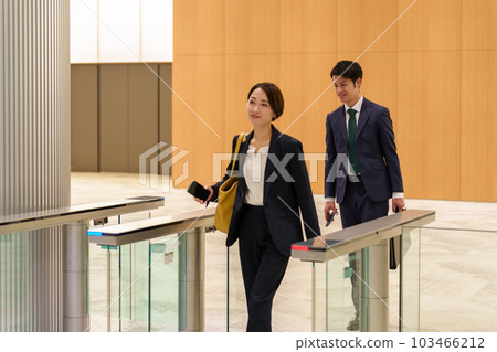 Business person passing through the gate with a smartphone 103466212