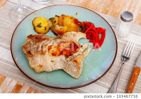 Delicious pork with boiled potatoes and stewed peppers on plate 103467738