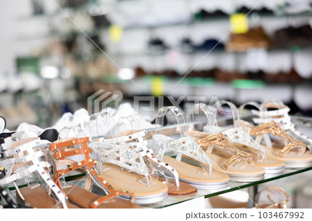 Fashionable summer women shoes on the shelves of shoe store Fashionable summer women shoes on the shelves of shoe store 103467992