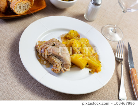 Pork stewed with potatoes and onions, served with pickled green olives and wine Pork stewed with potatoes and onions, served with pickled green olives and wine 103467996