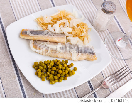 Light salted herring with marinated cabbage and green peas 103468144