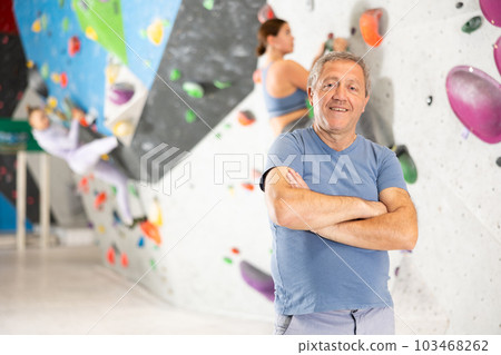 Adult man posing on climbing wall 103468262