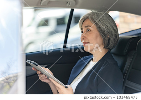 Business woman riding a car 103469473