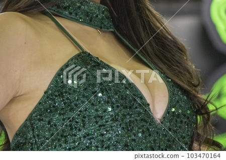 Breasts of a woman in a green costume Breasts of a woman in a green costume 103470164