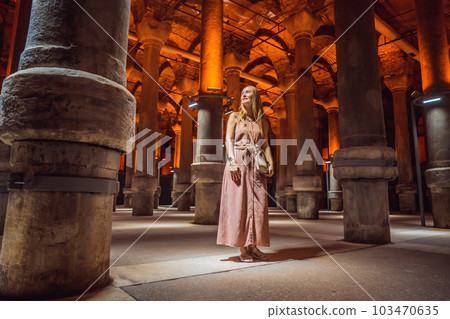 Woman tourist enjoying Beautiful cistern in Istanbul. Cistern - underground water reservoir build in 6th century, Istanbul, Turkey, Turkiye Woman tourist enjoying Beautiful cistern in Istanbul. Cistern - underground water reservoir build in 6th century, Istanbul, Turkey, Turkiye 103470635