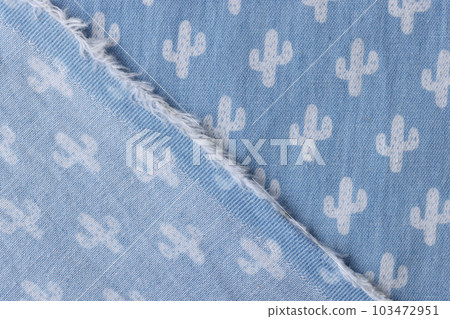 Wrapped corner of blue denim fabric with white cactus pattern 103472951