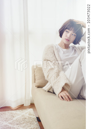 Young woman relaxing on the sofa (with filter) 103473022