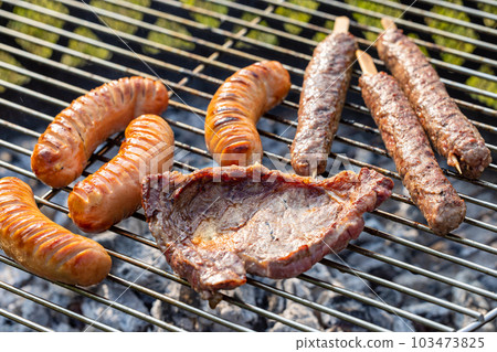 various grilled meat and sausages 103473825