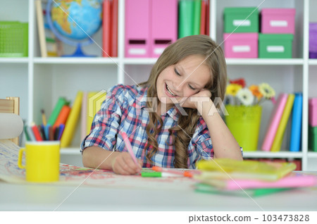 girl drawing picture at desk at home 103473828